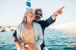 Older couple smiling laughing and enjoying their time on the water.
