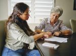A daughter talking with one of her aging loved ones about her estate planning.